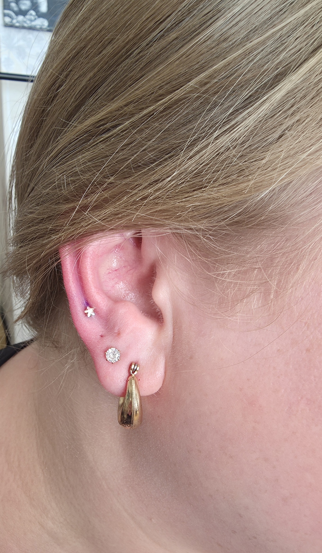 Helix and lobe ear piercings with gold jewellery
